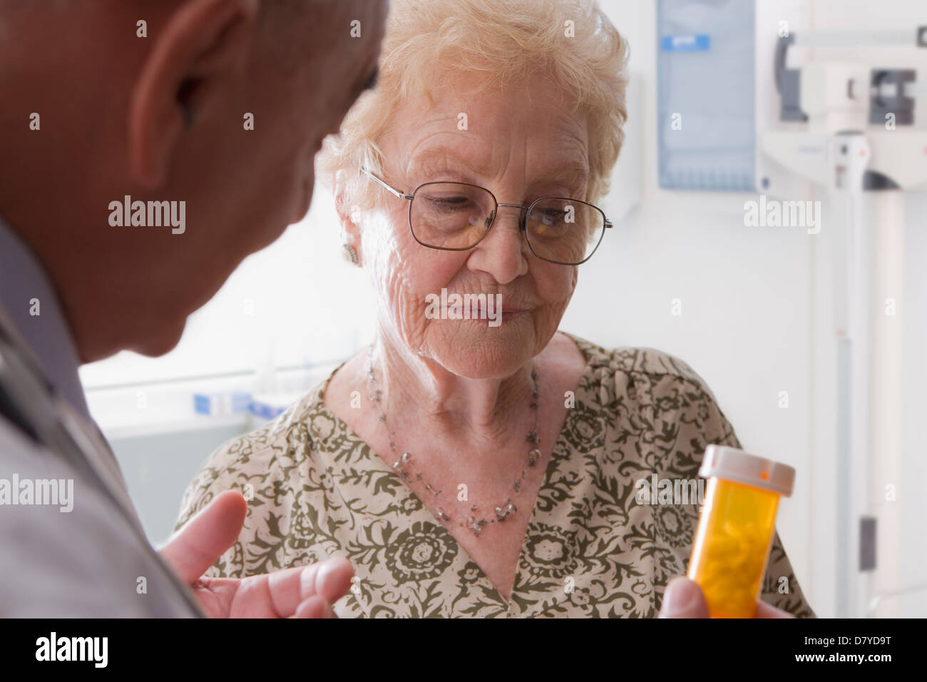 Hispanic doctor talking with older patient Stock Photo