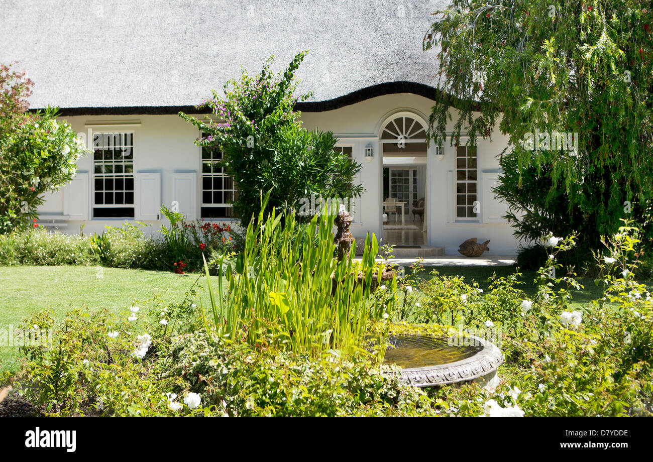 Birdbath in garden outside house Stock Photo