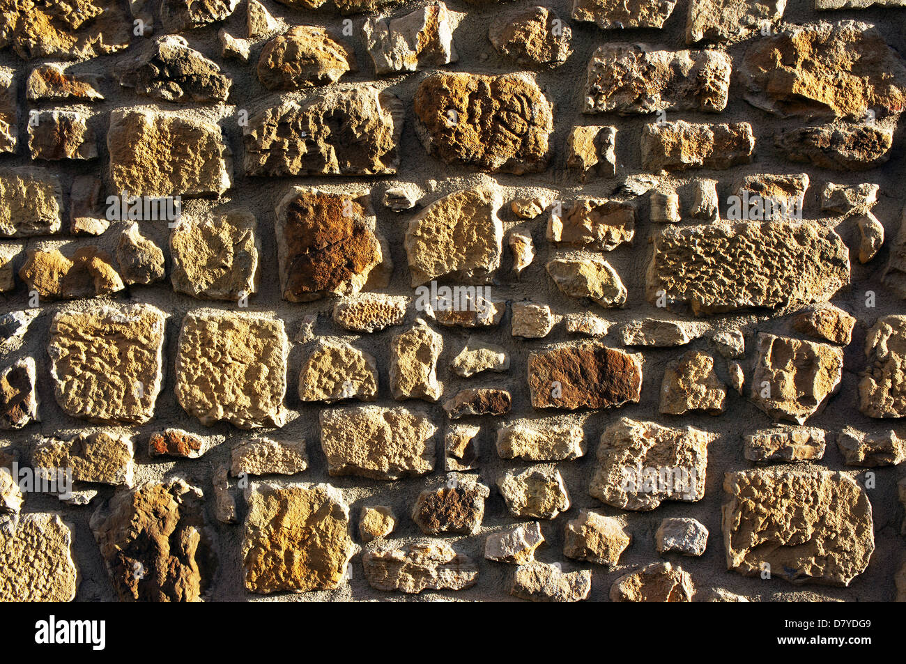 background of a wall of textured sand rocks Stock Photo