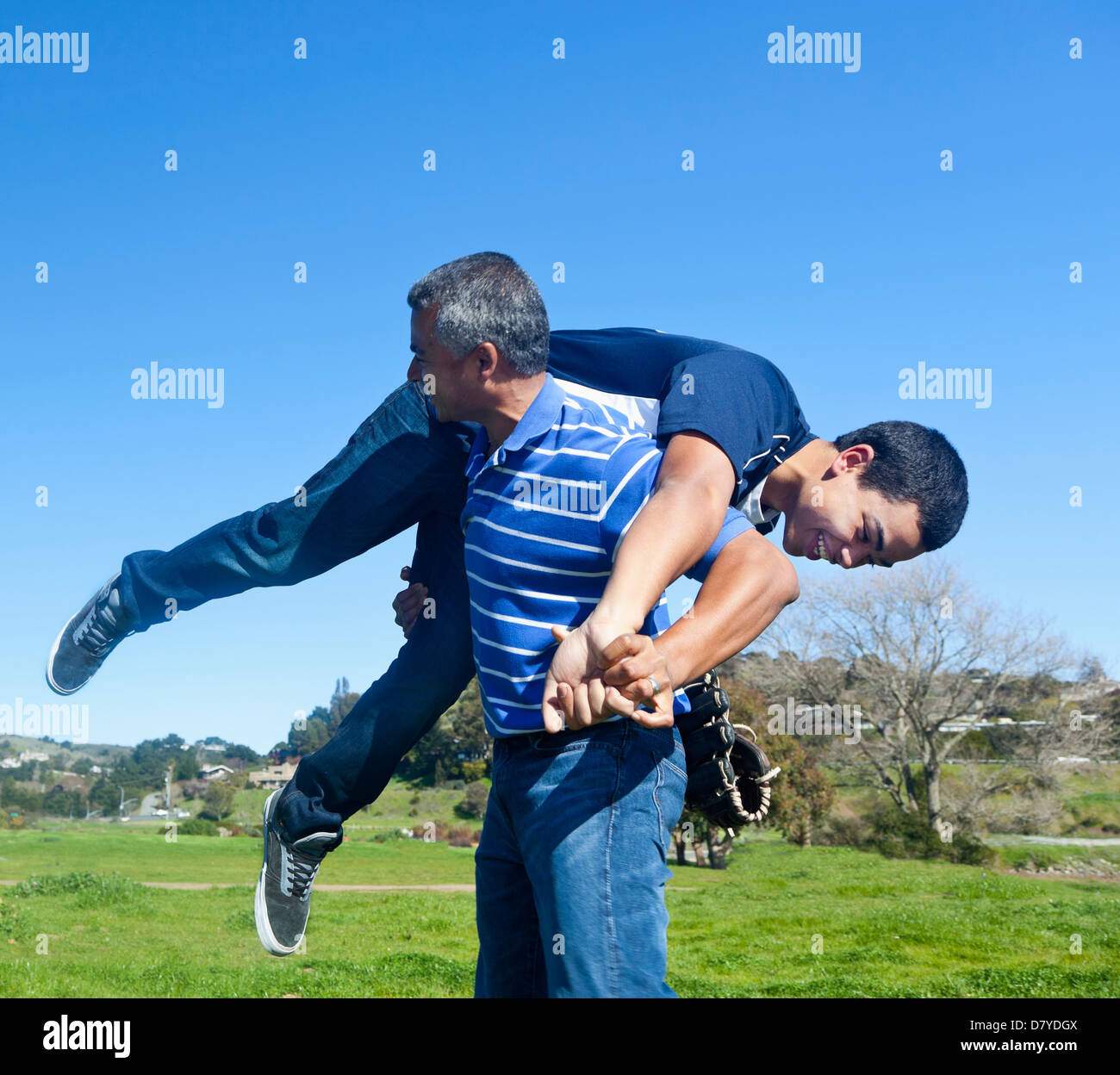 Hispanic father and son playing in park Stock Photo - Alamy
