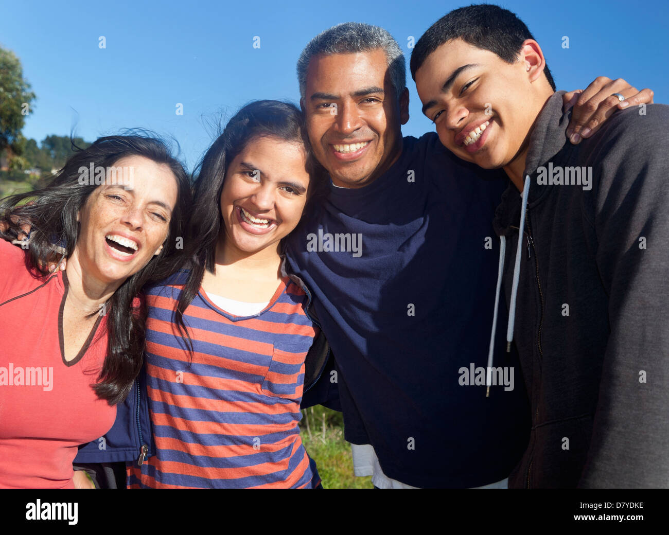 Hispanic family smiling in park Stock Photo - Alamy