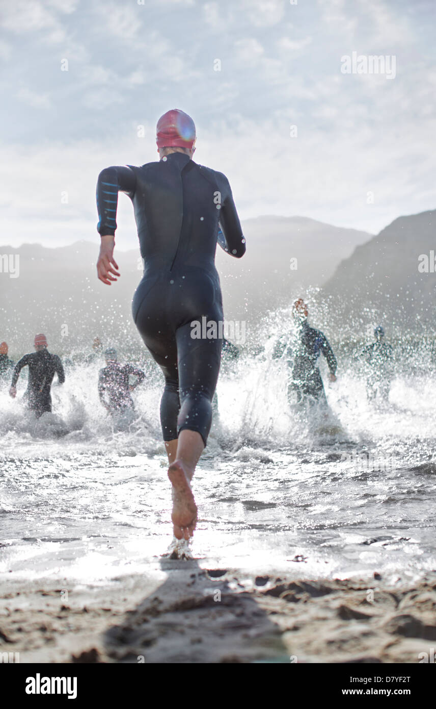 Triathletes at start of swimming race Stock Photo - Alamy
