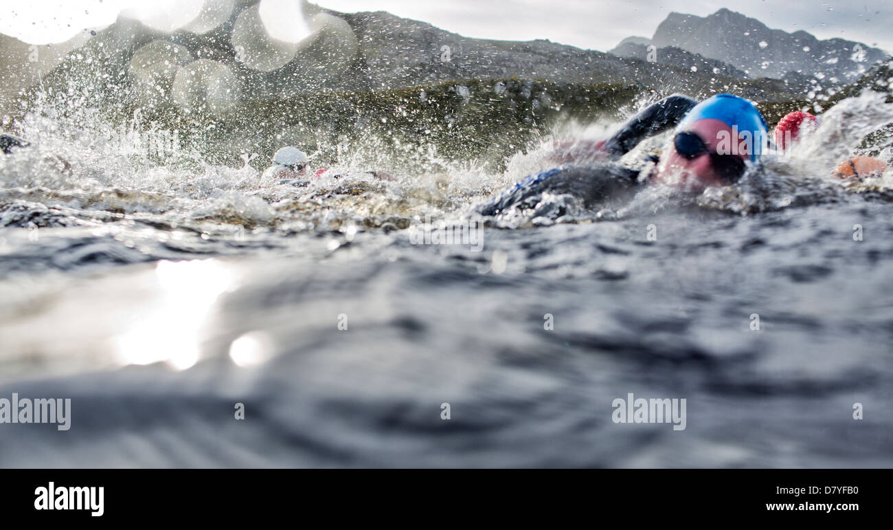 Swimmers splashing in water Stock Photo