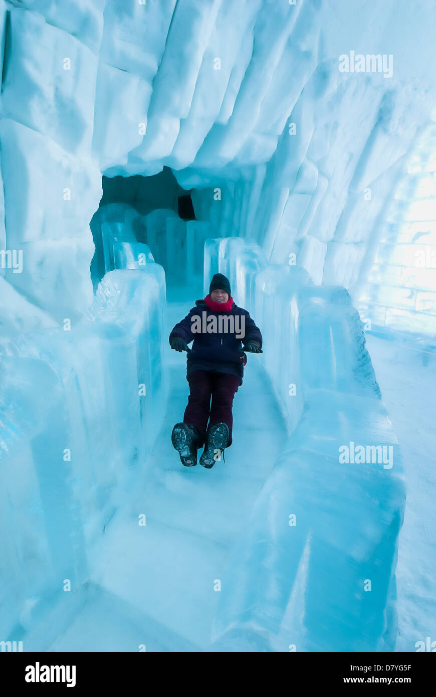 Woman slides down the ice slide, Hotel de Glace, Ice Hotel, Quebec City, Quebec, Canada. Stock Photo