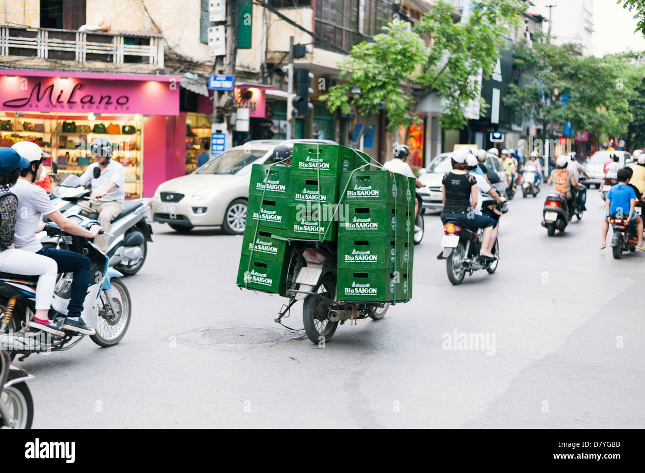 Hanoi, Vietnam - crates of Vietnamese beer being transported by overloaded motor scooter Stock Photo