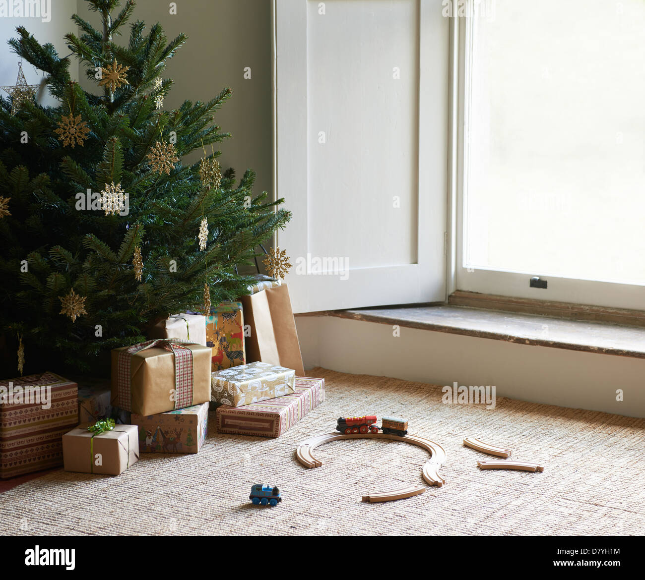 Train set and Christmas gifts under tree Stock Photo