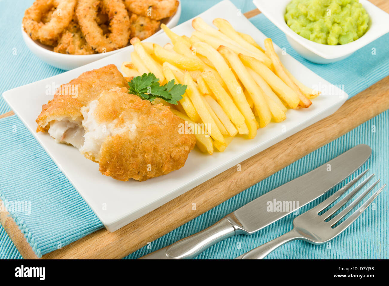 Fish & Chips - Battered cod fillet, chips and mushy peas. Stock Photo