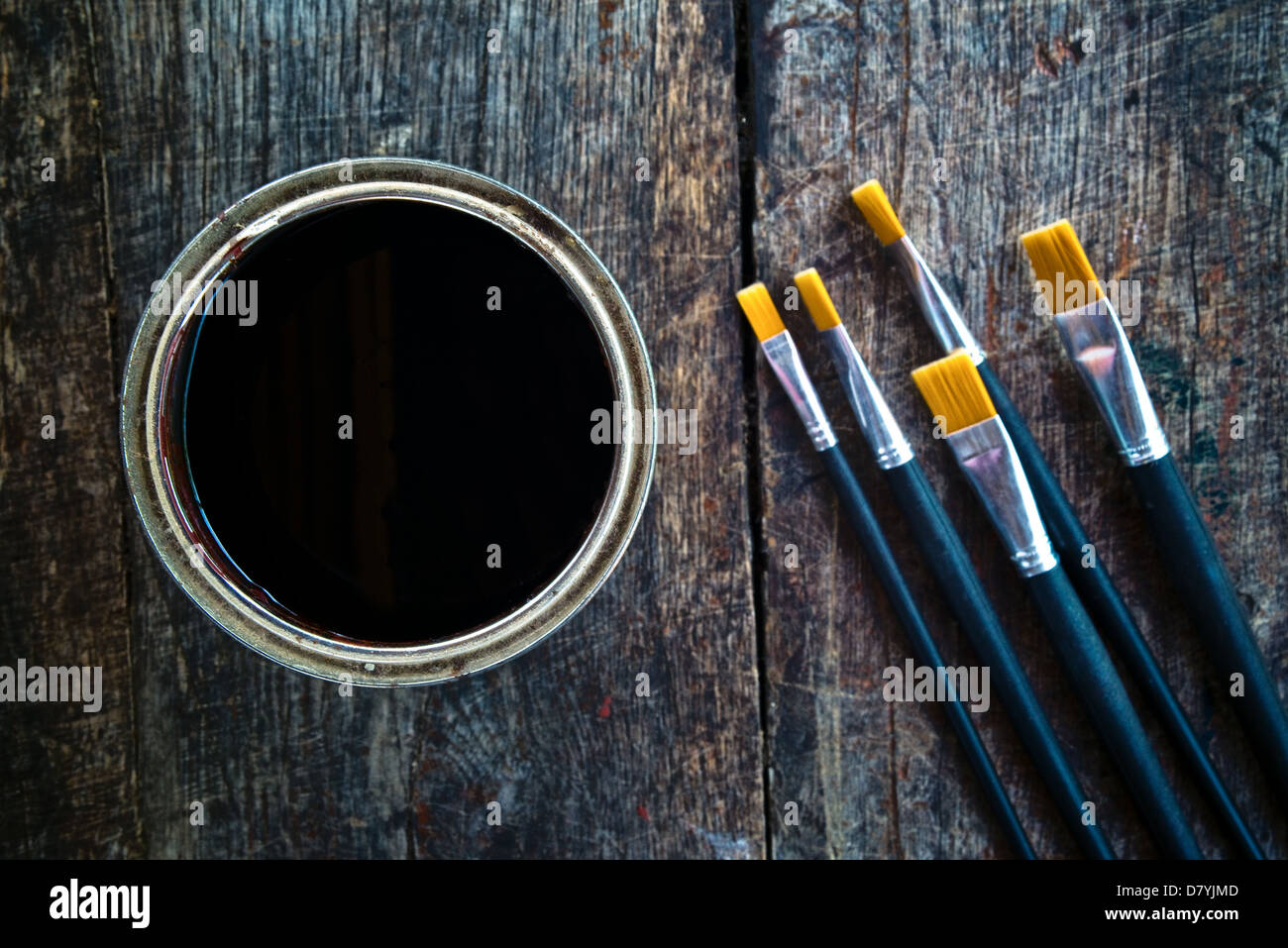 Paint brushes and paint can on old wood background Stock Photo - Alamy