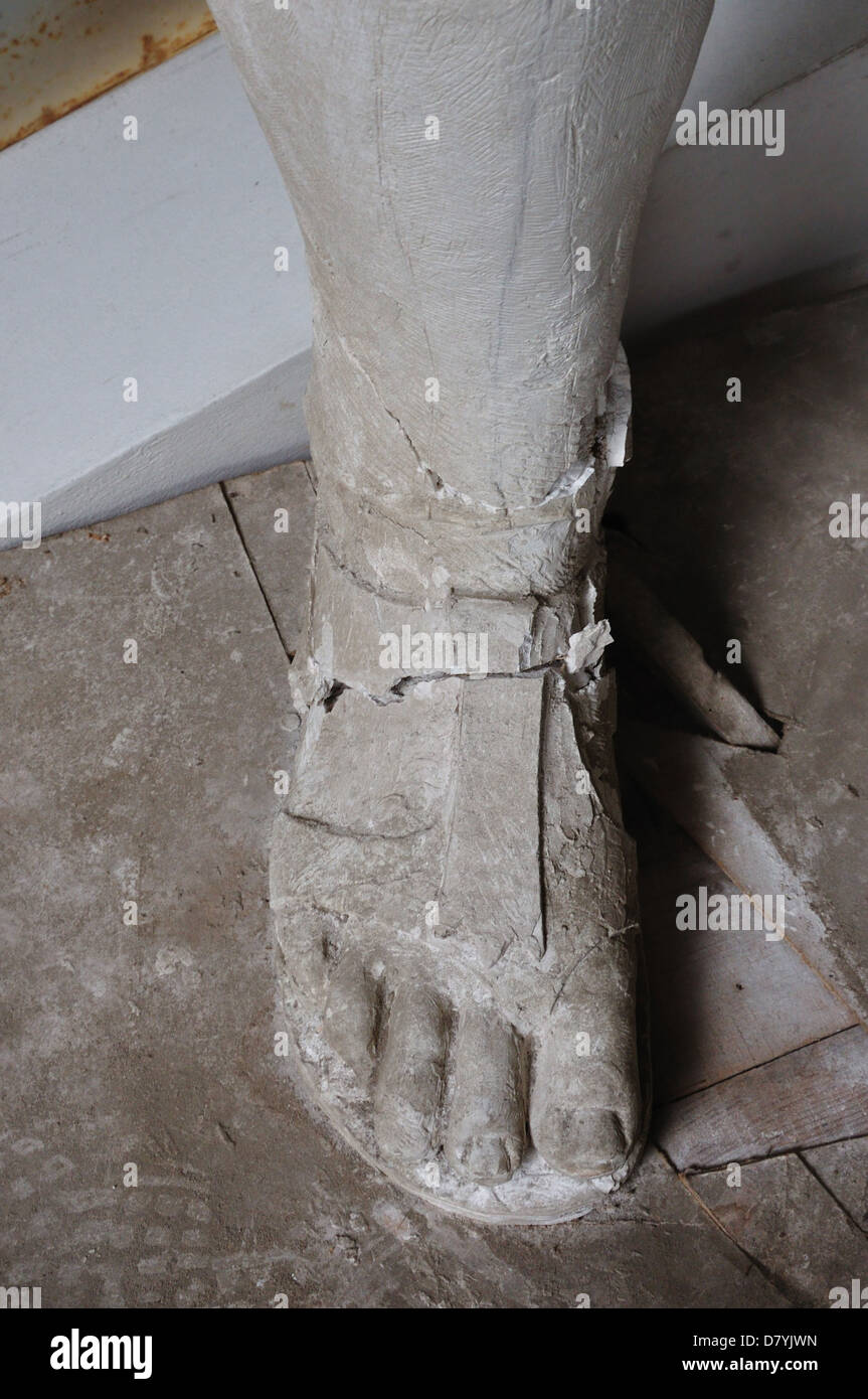 Broken plaster statue foot detail in the abandoned studio of sculptor