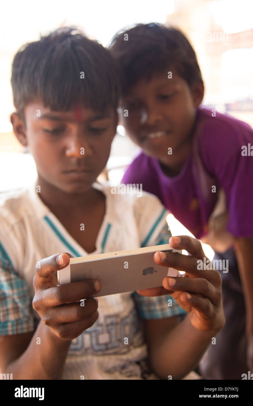 Indian boy using an iPhone 5, Gwalior, Madhya Pradesh, India Stock Photo