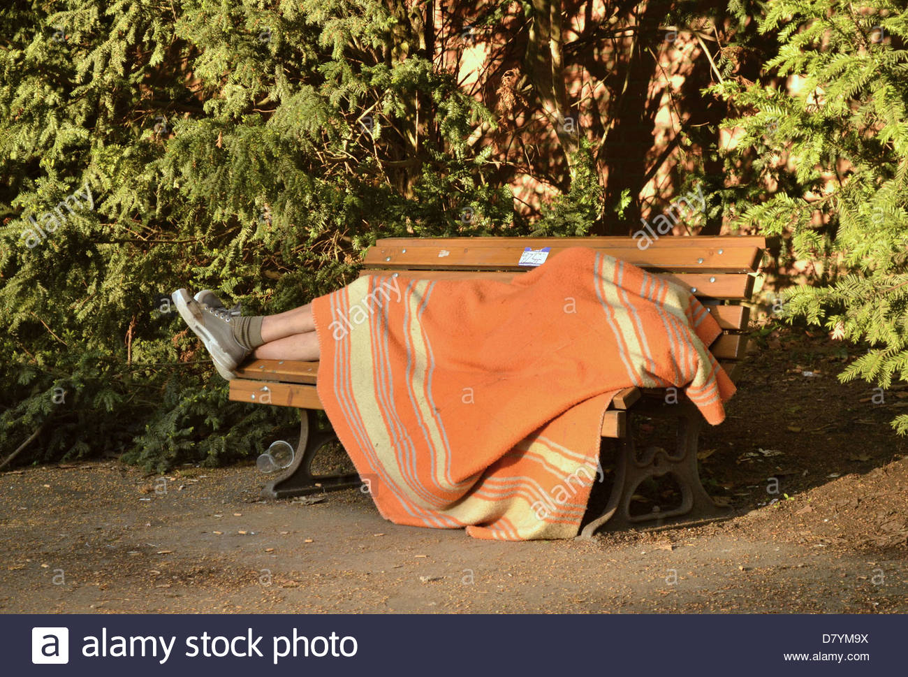 Homeless Covered Blanket Sleeping On Stock Photos & Homeless Covered