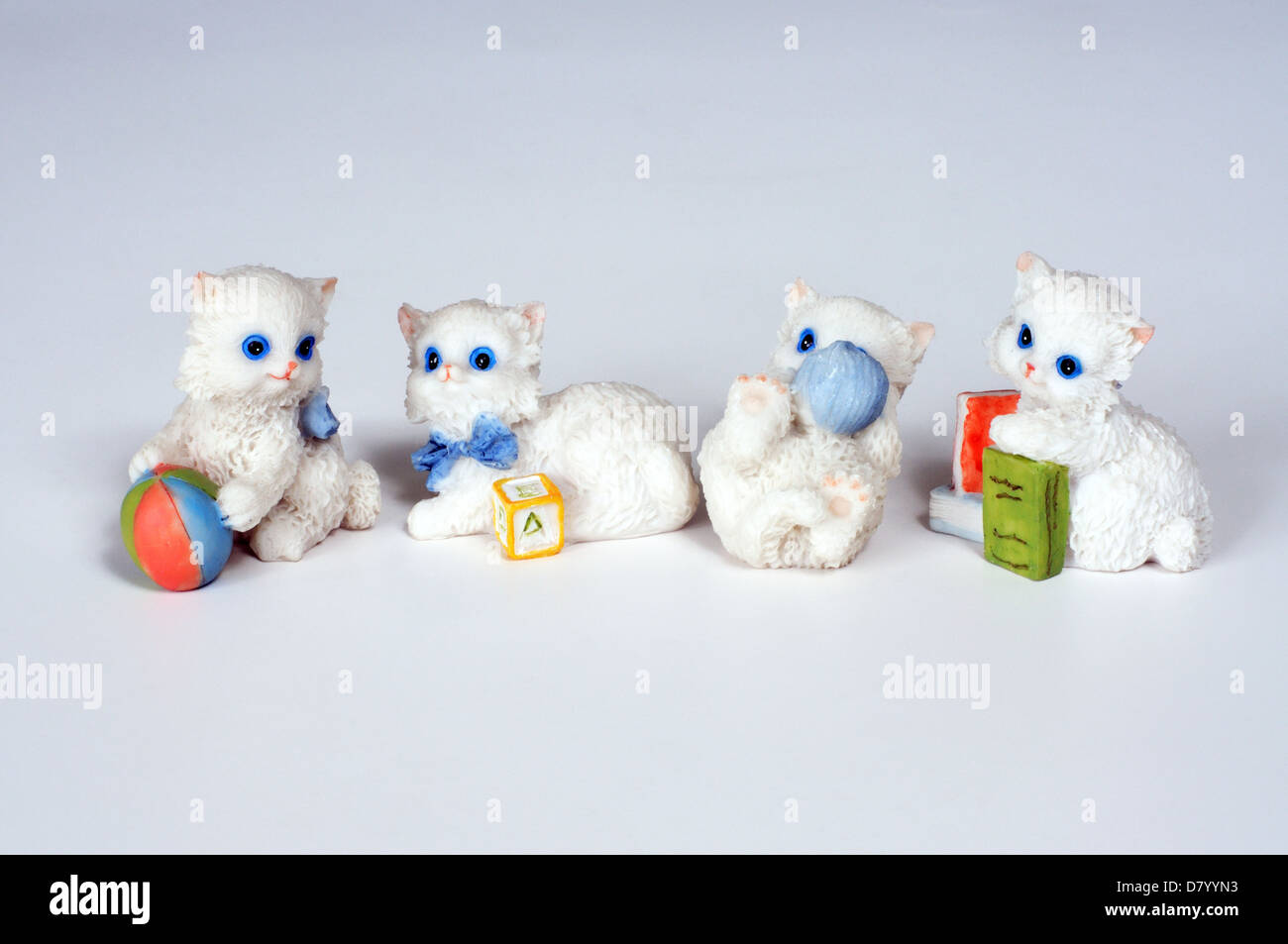 Four white kittens playing ornaments against a white background. Stock Photo