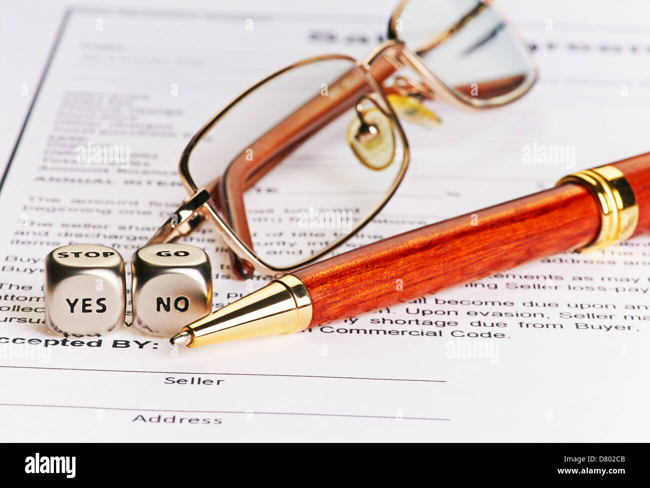 Contract with glasses, pen and dices cubes with words YES NO. Selective