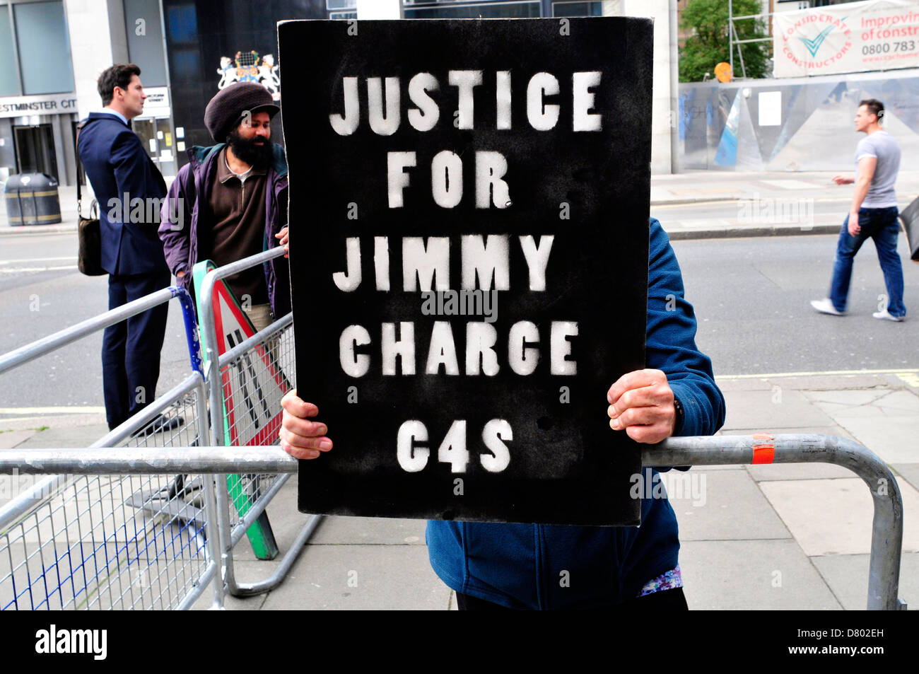 A protester with a banner reading ' Justice for Jimmy, charge G4S', in central London, UK. Stock Photo