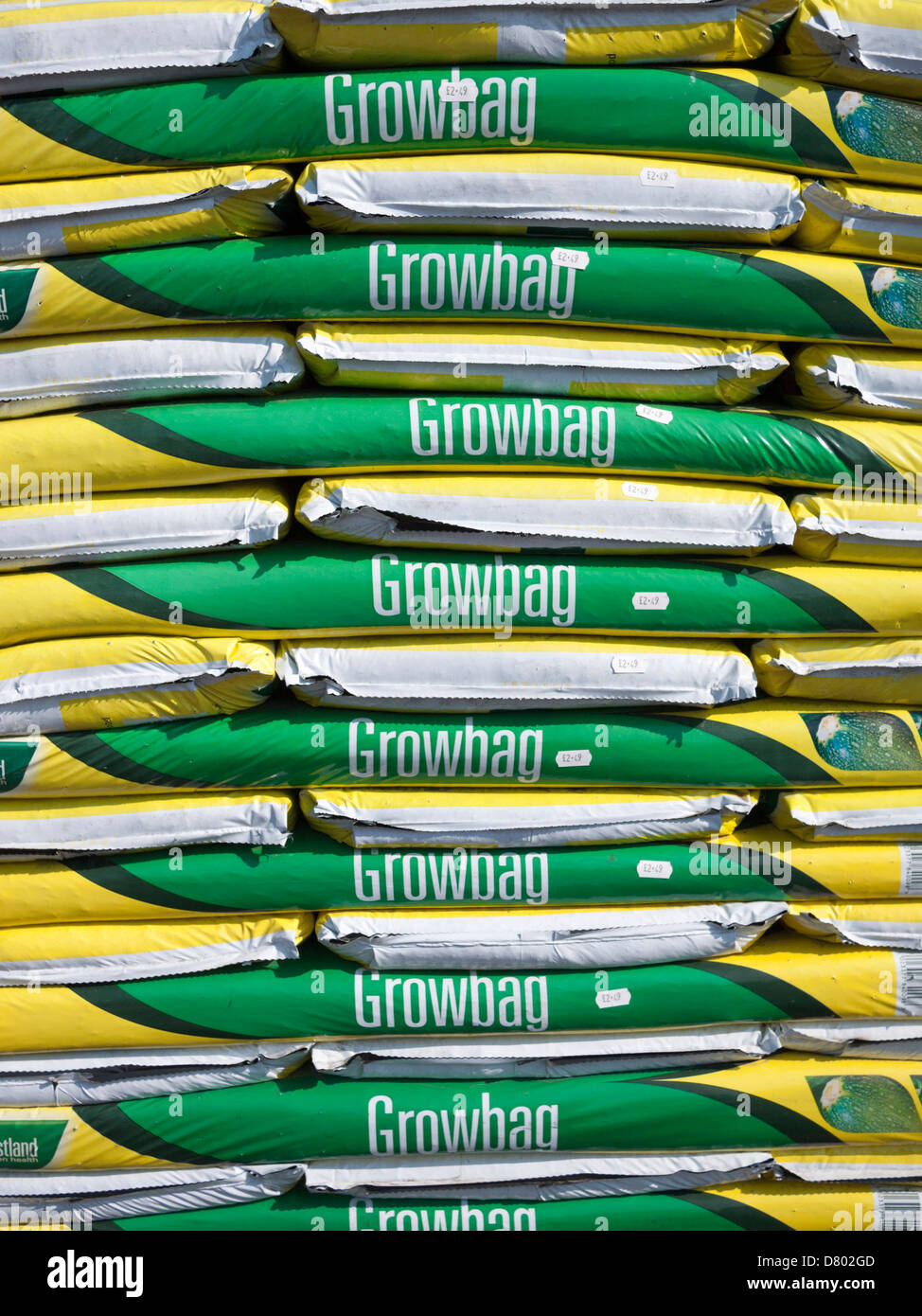 A pile of grow bags at a garden centre in the UK. The bags are full of compost and used to grow vegetables and plants. Stock Photo