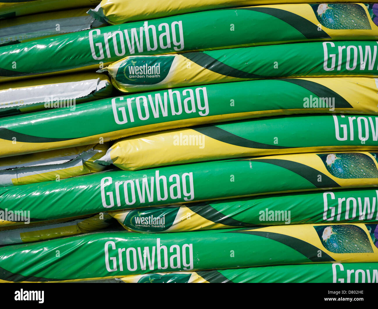 A pile of grow bags at a garden centre in the UK. The bags are full of compost and used to grow vegetables and plants. Stock Photo