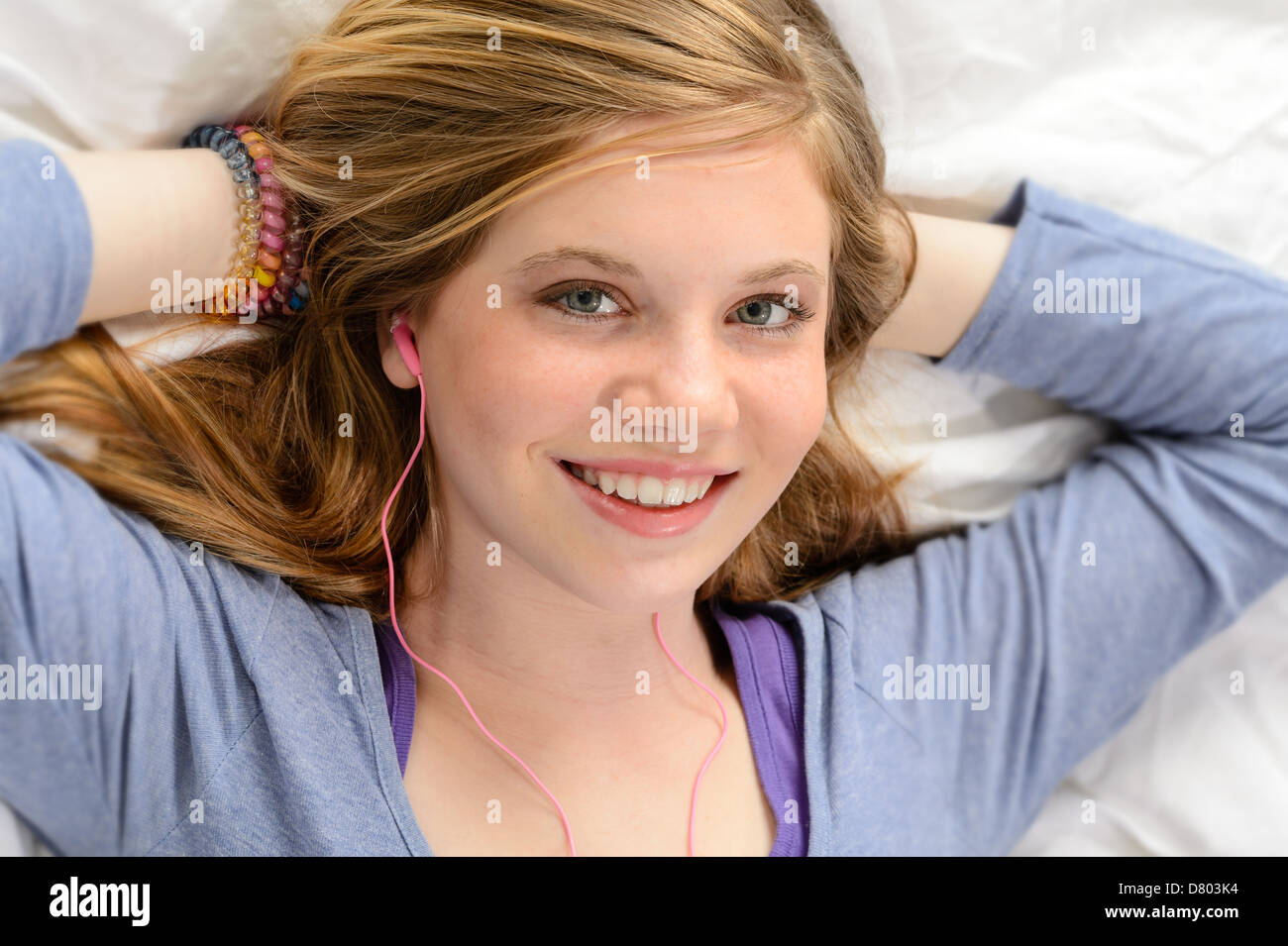 Portrait of relaxing lying young girl listening to music Stock Photo ...