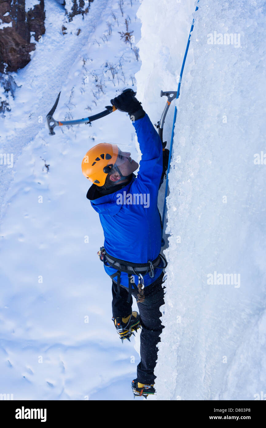 Caucasian climber scaling glacier Stock Photo