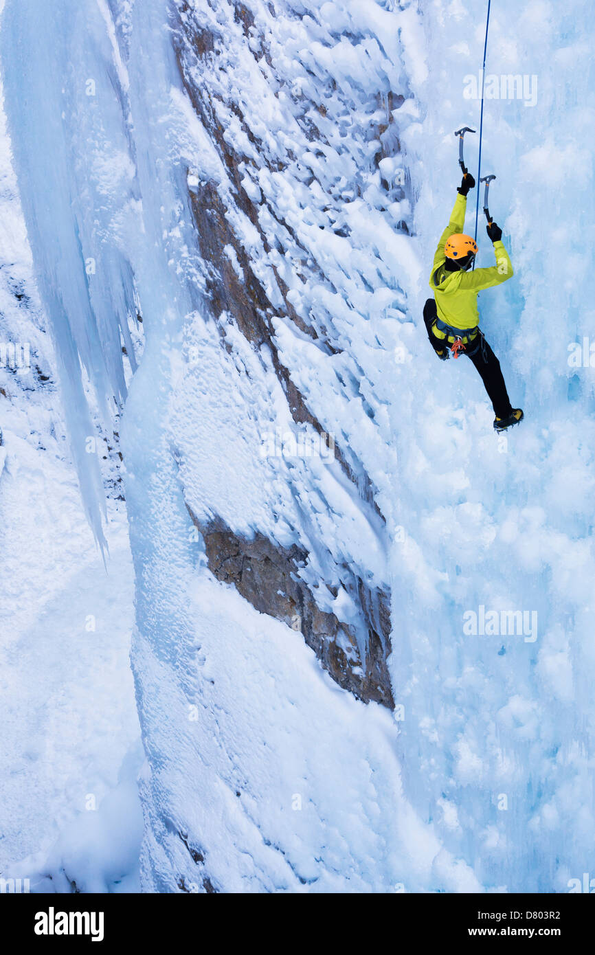 Caucasian climber scaling glacier Stock Photo