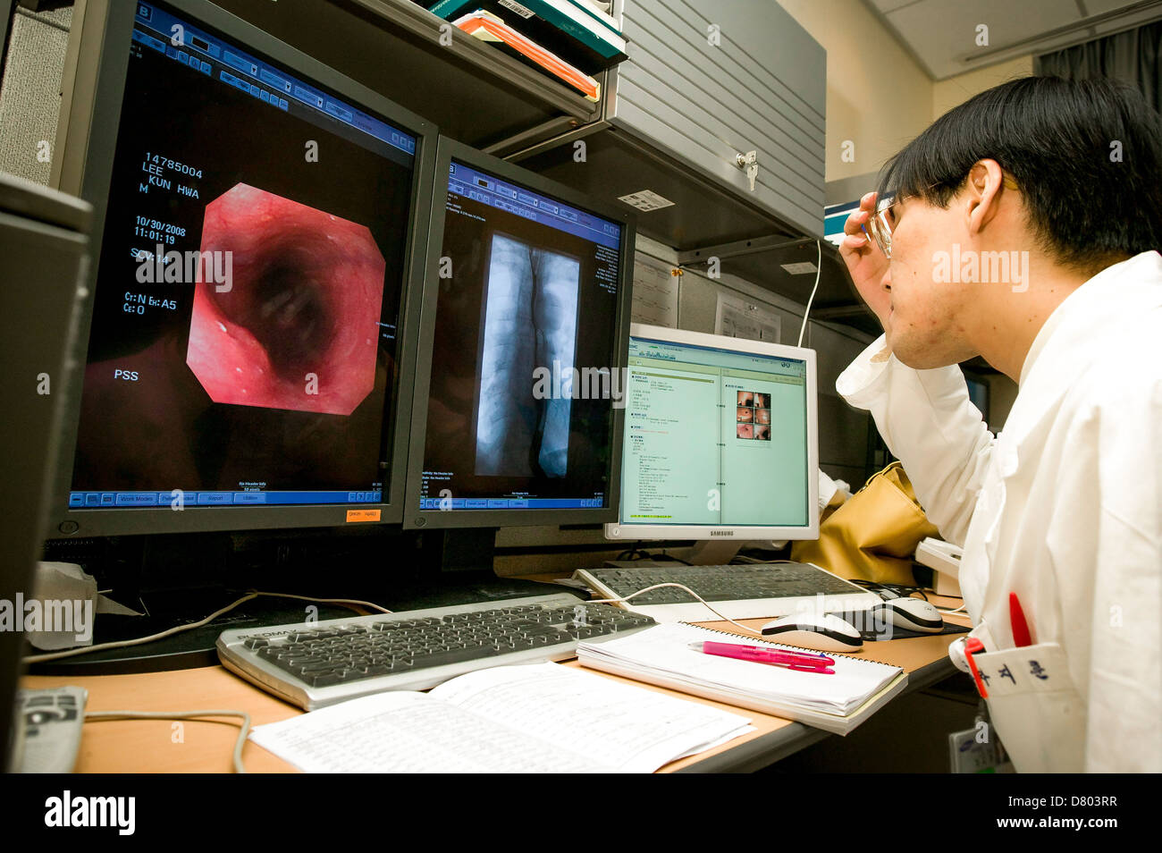 A doctor views endoscopic images, as part of patient diagnosis, in the Reading Room, in a Medical Centre. Stock Photo