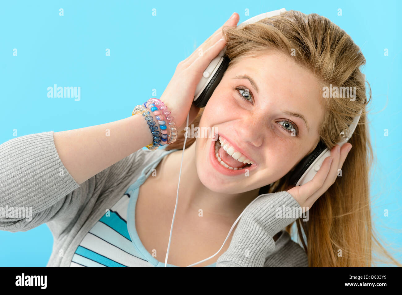 Cheerful girl listening to music with headphones Stock Photo - Alamy