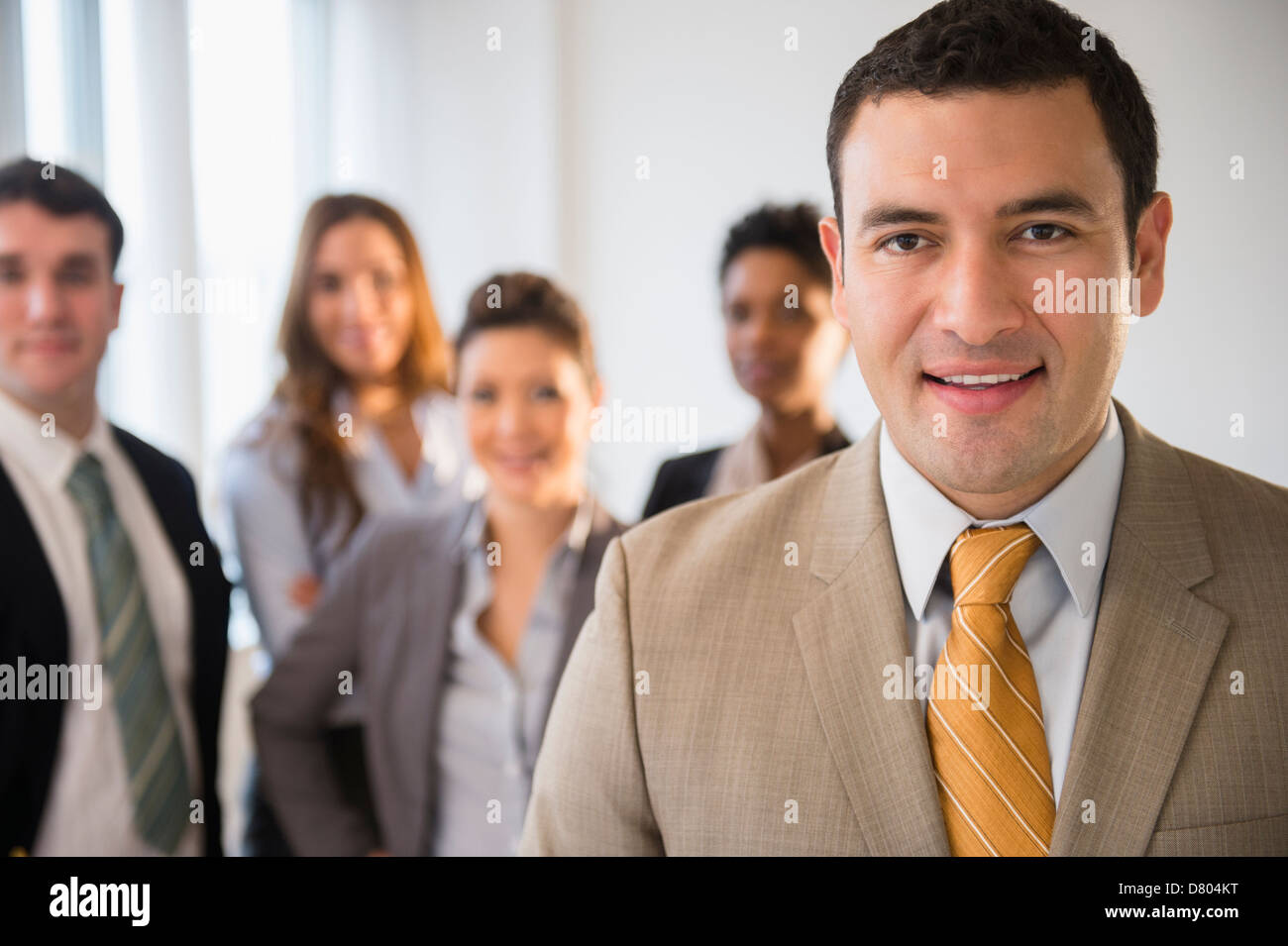 Businessman smiling in office Stock Photo - Alamy