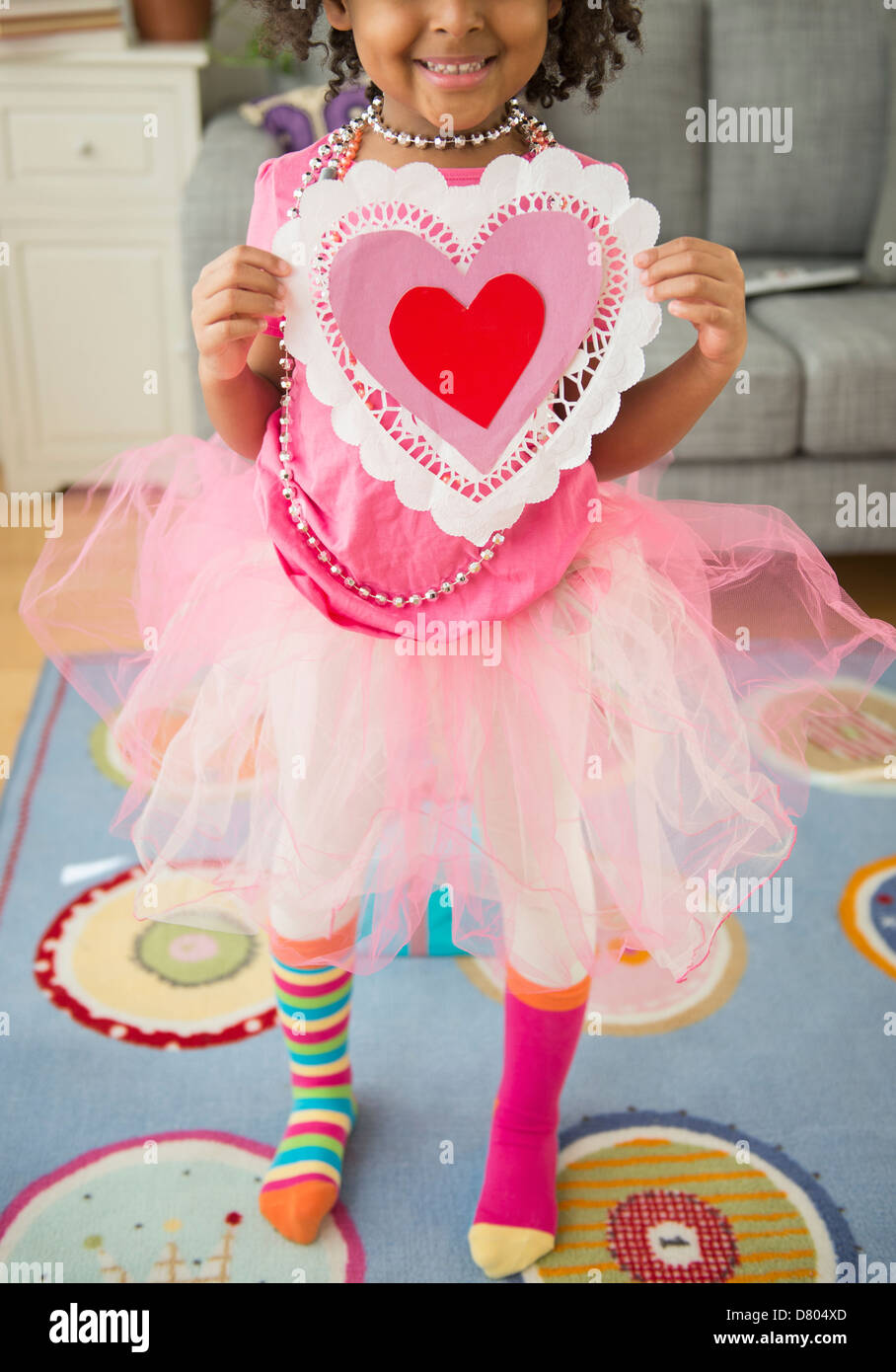 African American girl holding Valentine's Day card Stock Photo