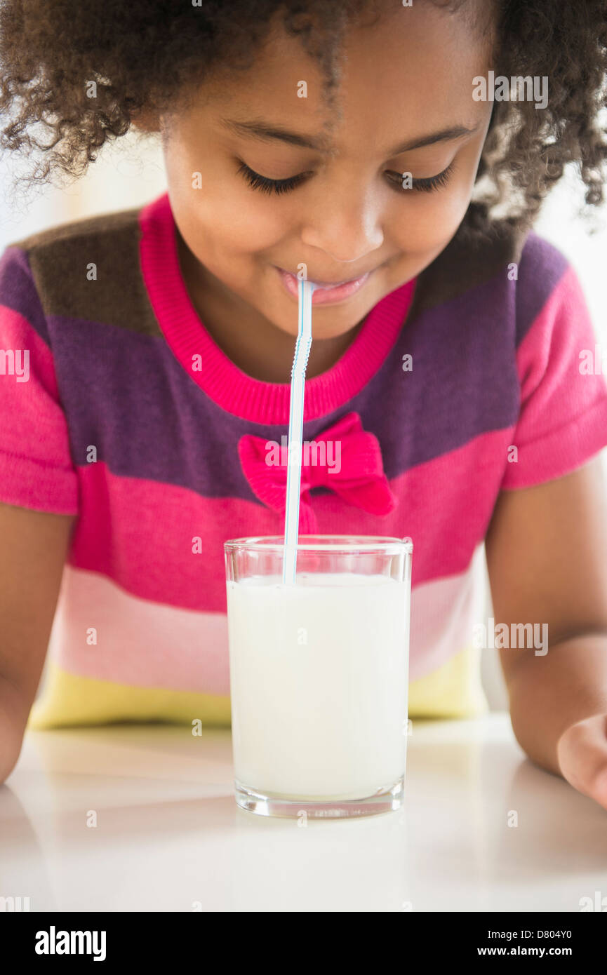 African American girl drinking glass of milk Stock Photo