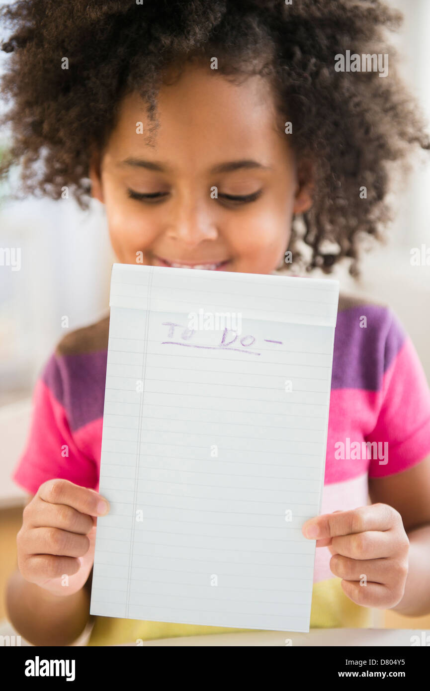 African American girl holding to do list Stock Photo