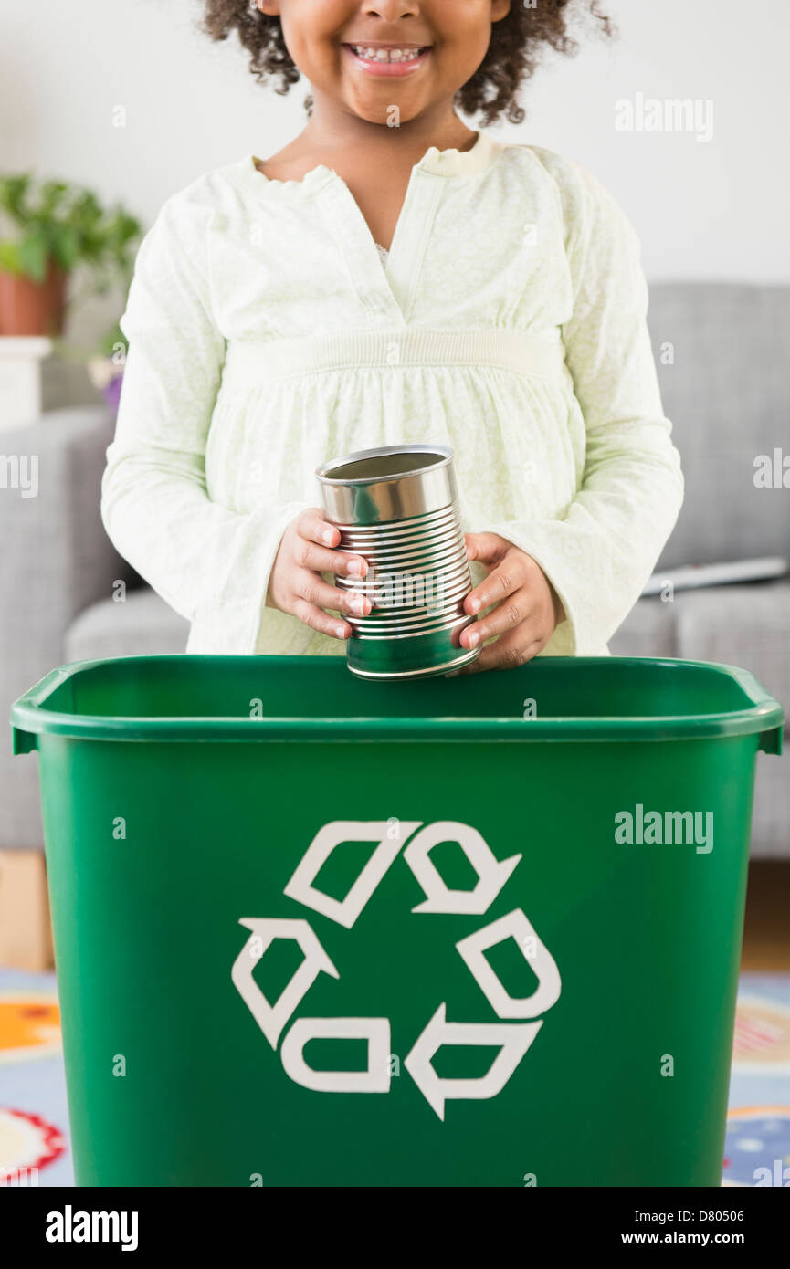 African American girl recycling can Stock Photo