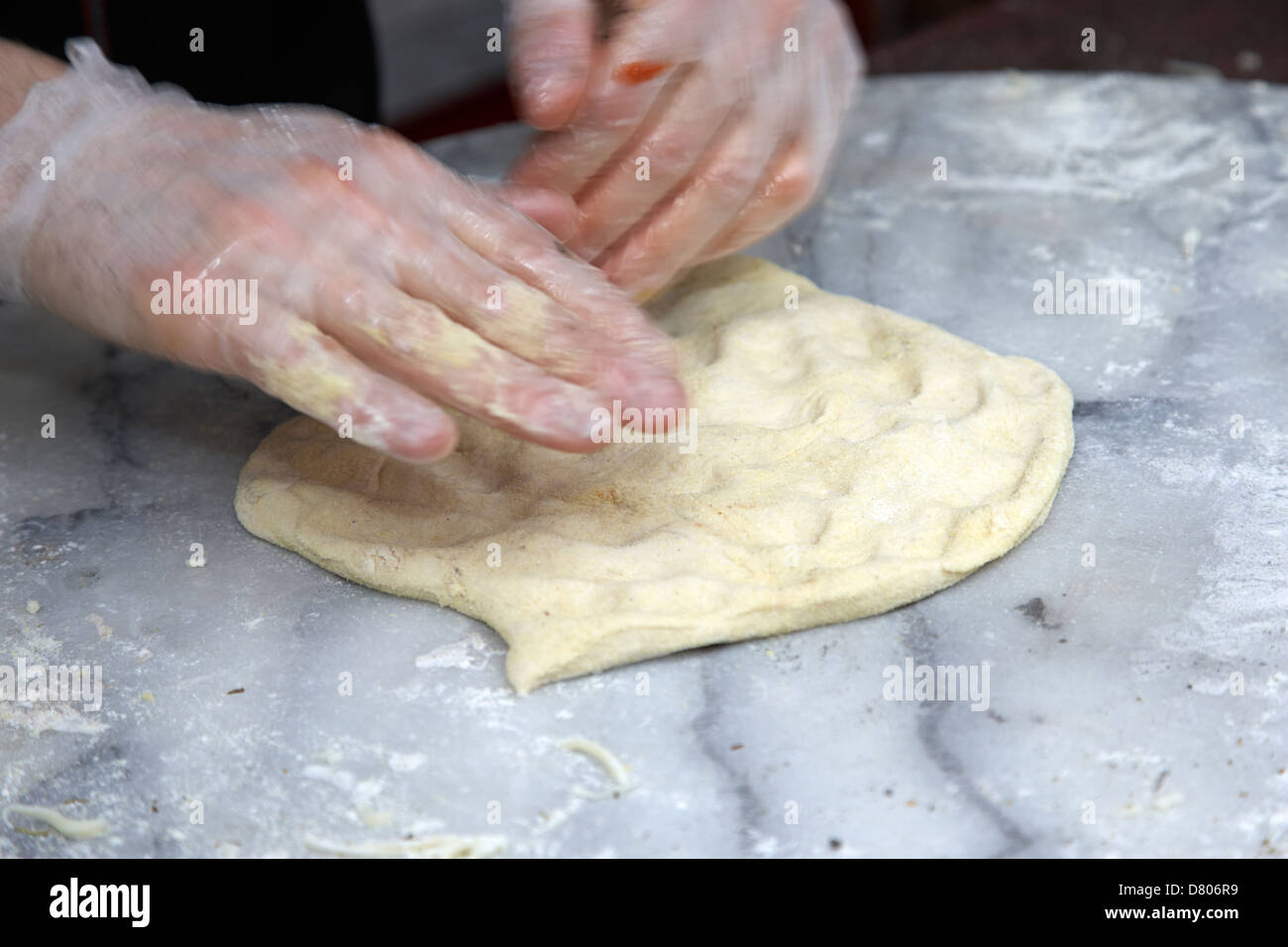 man making pizza kneeding base dough deliberate motion blur Stock Photo