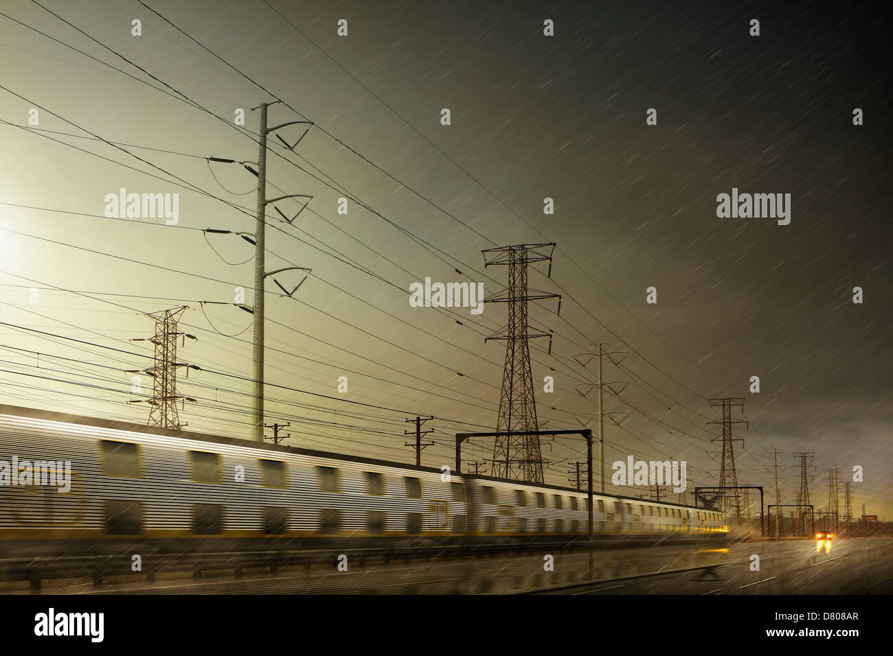 Train speeding by power lines Stock Photo