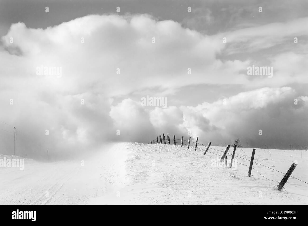 Clouds and wooden fence in snowy landscape Stock Photo - Alamy