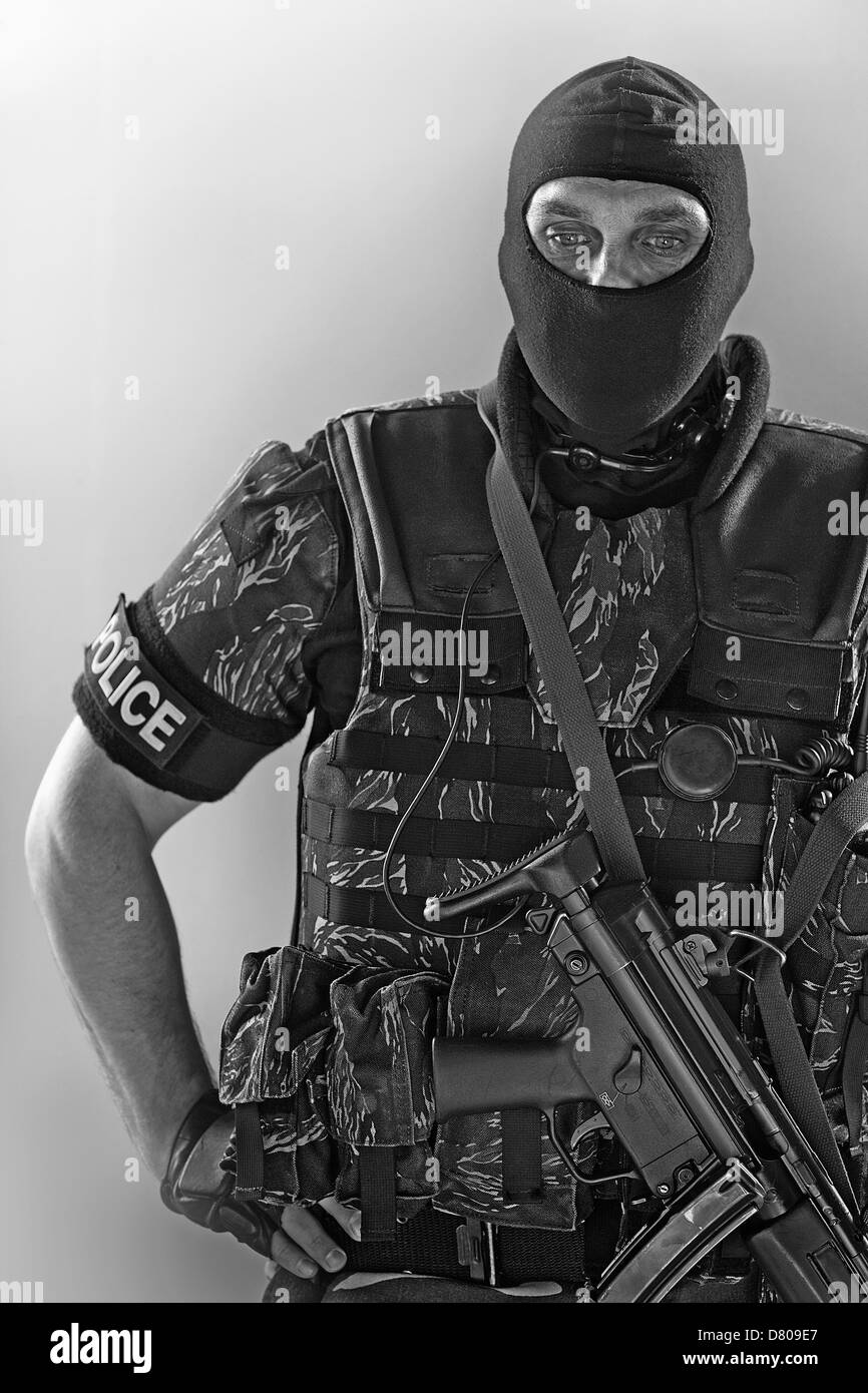 Policeman wearing machine gun and vest Stock Photo