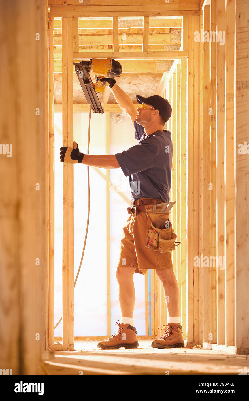 Caucasian carpenter working on building Stock Photo - Alamy