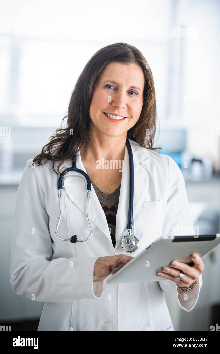 Caucasian doctor using tablet computer in office Stock Photo