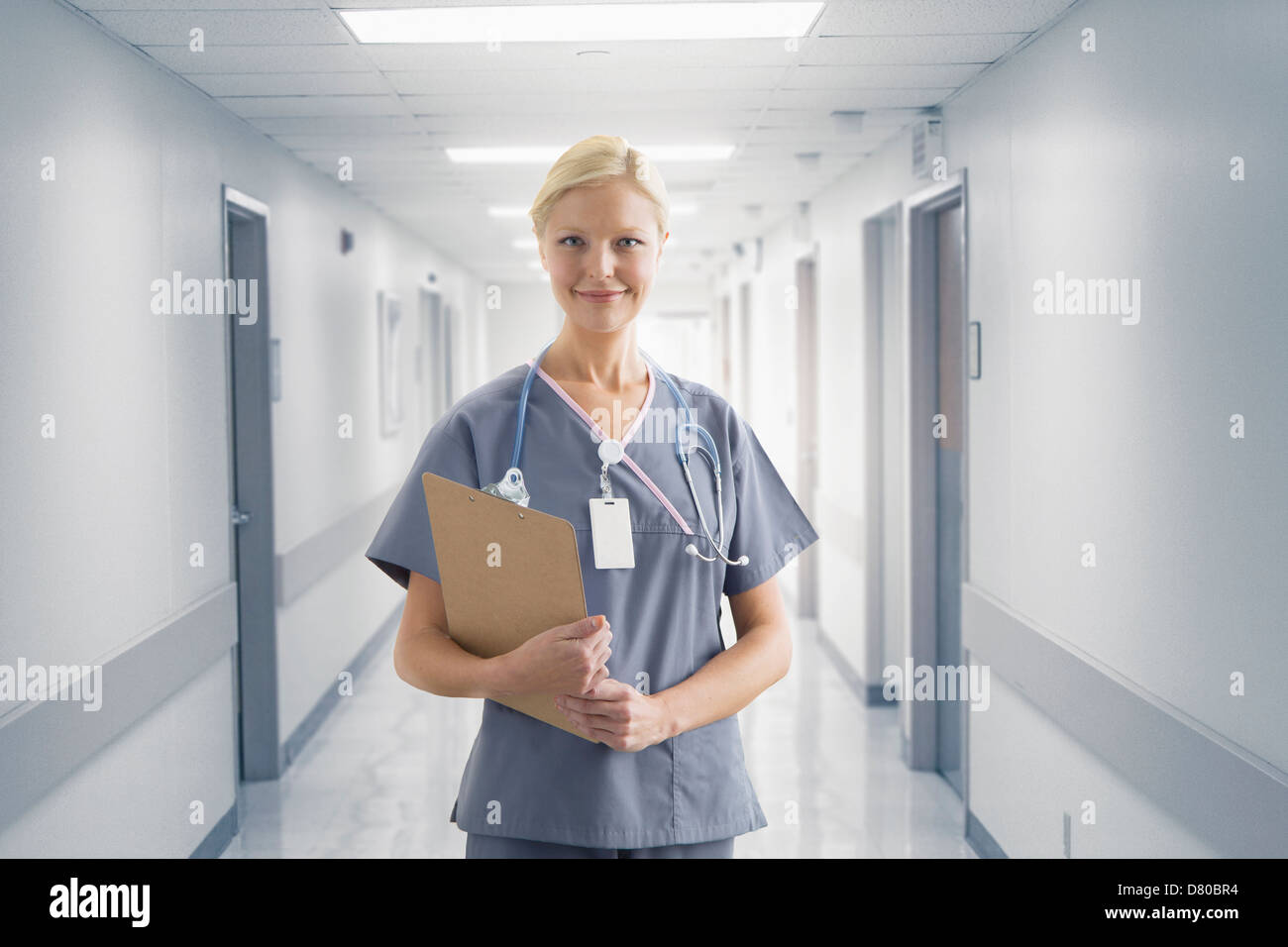 Caucasian nurse smiling in hospital Stock Photo