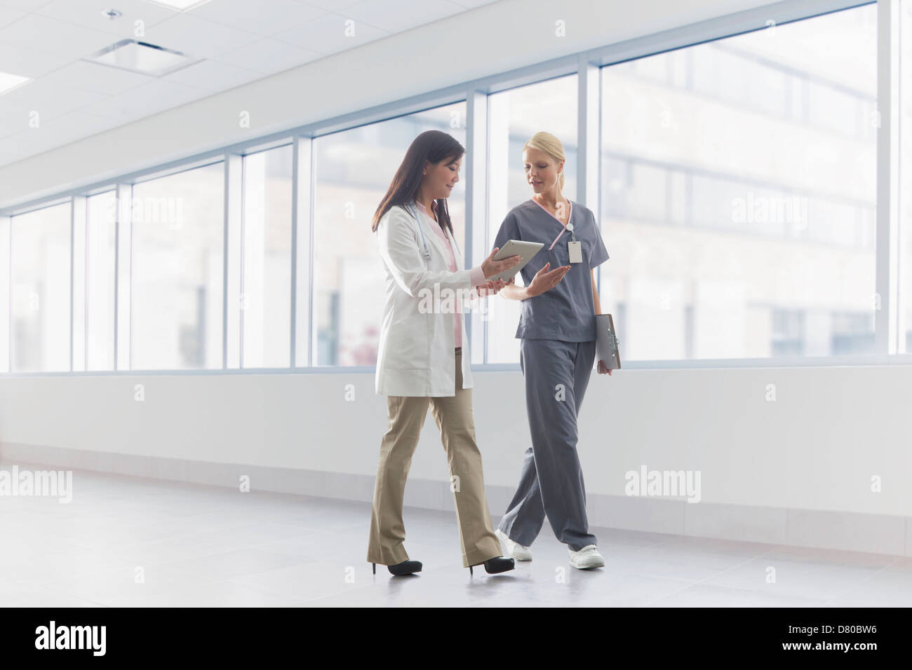 Doctor and nurse talking in hospital Stock Photo