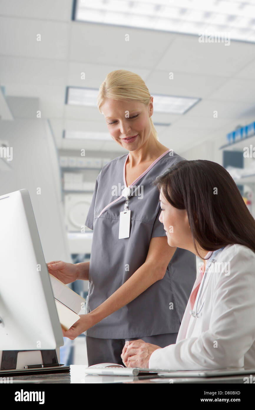 Doctor and nurse working at computer in hospital Stock Photo Alamy