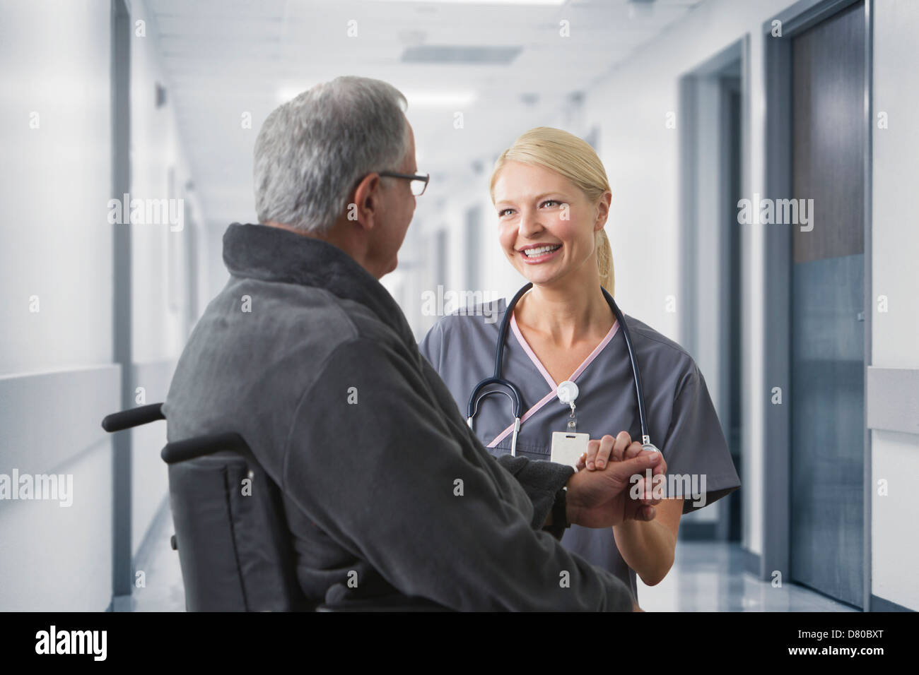 Caucasian nurse talking to patient in hospital Stock Photo