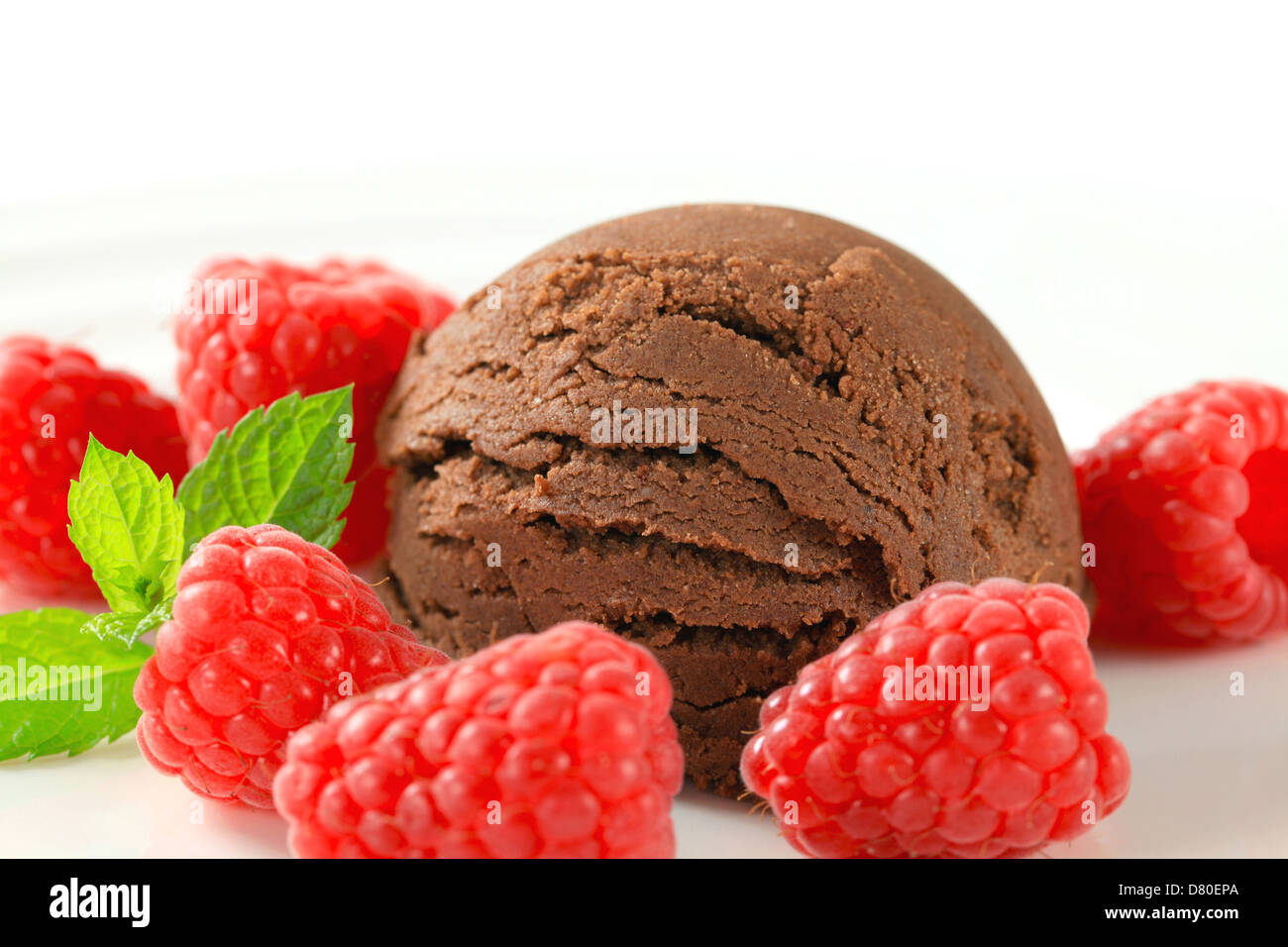 Scoop of chocolate ice cream with fresh raspberries Stock Photo