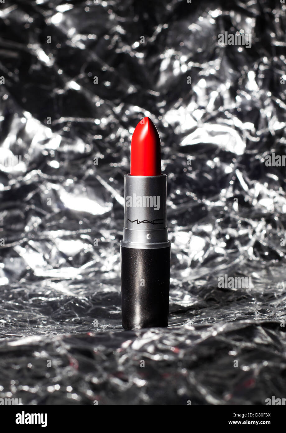 red lipstick against silver foil background Stock Photo