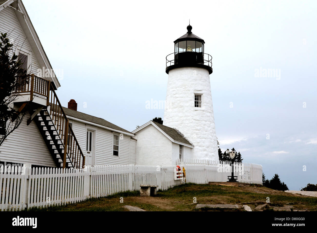 Burnt Island lighthouse, Maine, seen along the white picket fence around the keeper's cottage