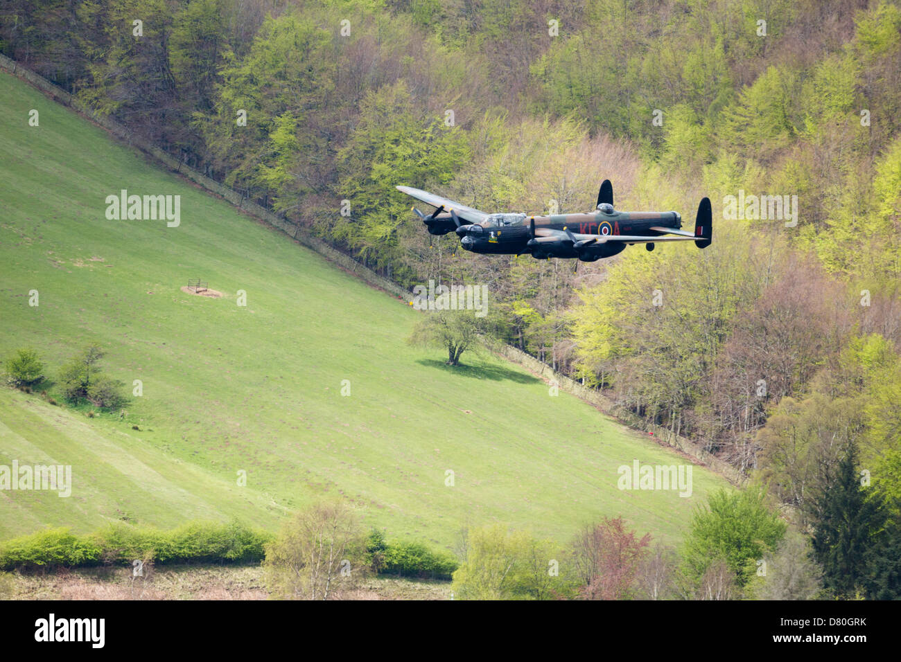 Derwent Reservoir, Derbyshire, UK. 16th May 2013. An RAF Lancaster Bomber plane flies over Ladybower Reservoir in the Upper Derwent Valley as part of the Dambusters 617 Squadron 70th Anniversary Commemorative Flypast. May 16th 2013. Derbyshire, Peak District. Credit:  Graham Dunn / Alamy Live News Stock Photo