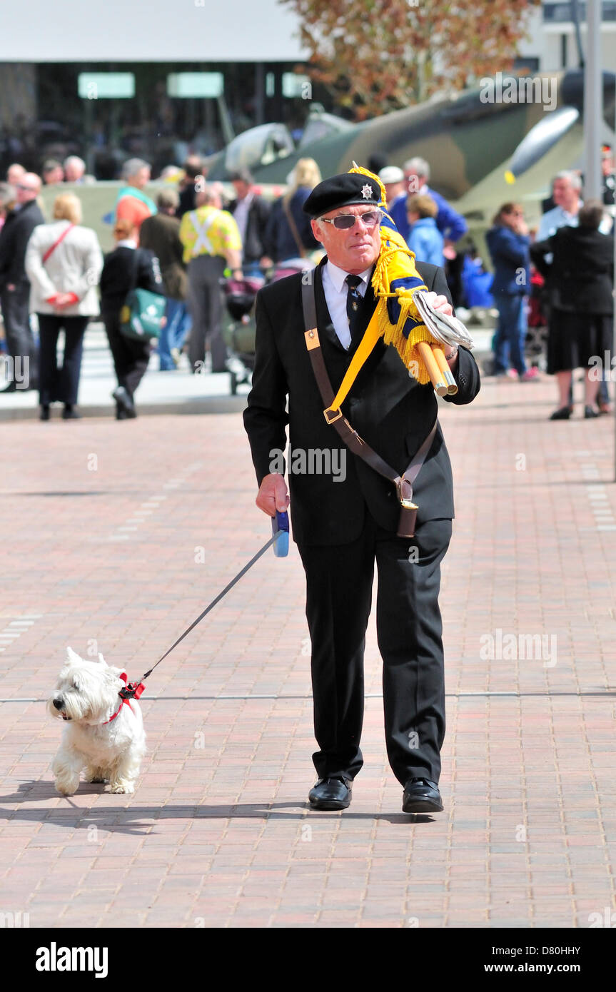 May 16th, 2013. Dambusters Raid 70th Anniversary Commemoration at Kings Hill, Kent, former site of the West Malling Airfield. Retired soldier with dog, carrying flag Stock Photo