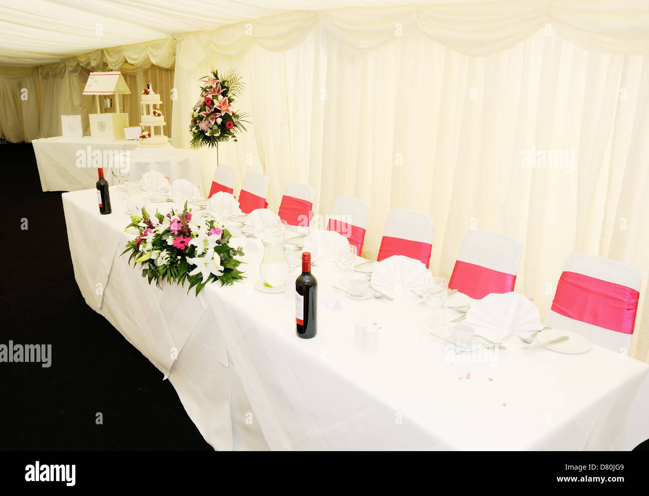 Wedding reception table showing decoration of flowers and cake Stock Photo