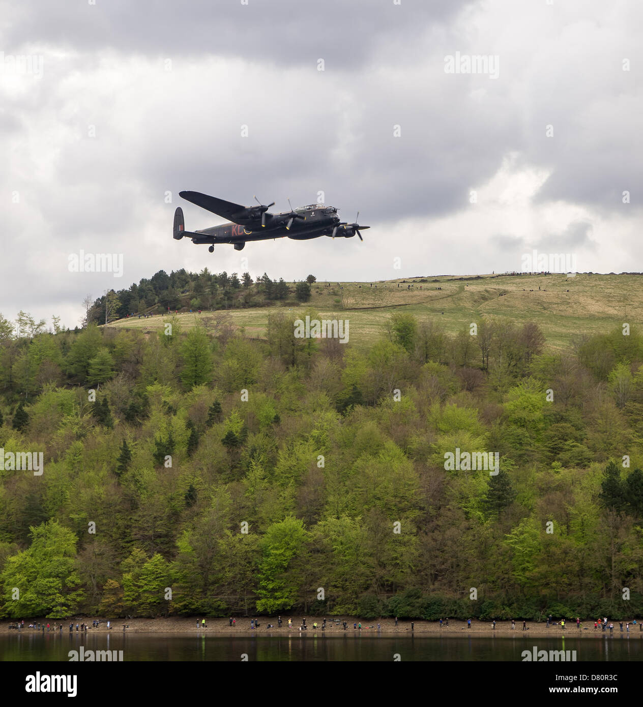 Derwent Reservoir, Derbyshire, UK. 16th May 2013. A Lancaster bomber of the Battle of Britain flight flying low over the Derwent Reservoir, Derbyshire on 16th May 2013. This marks the 70th anniversary of the dambusters raid by 617 Squadron. Credit:  Nigel Spooner / Alamy Live News Stock Photo