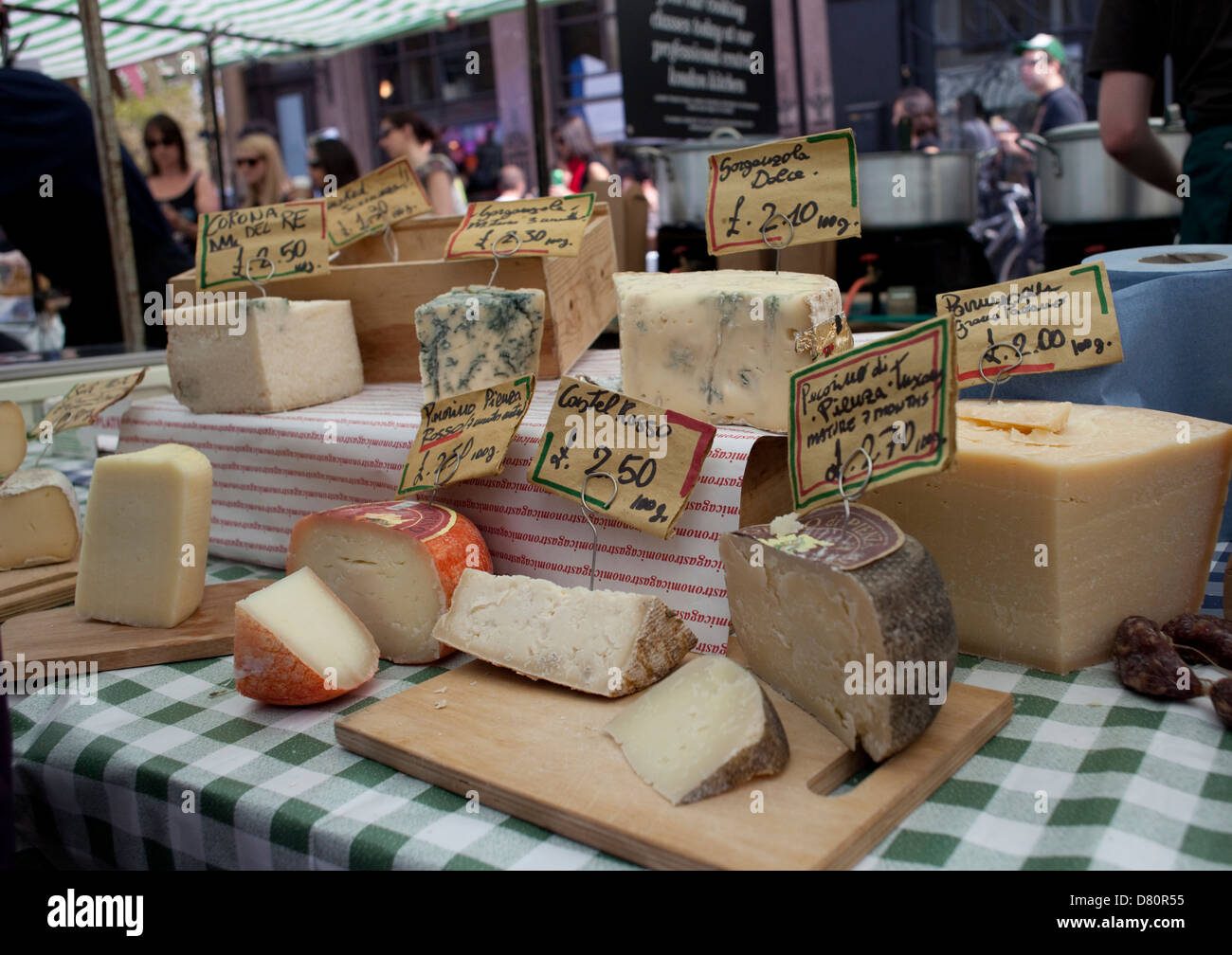 CHEESES ON CHEESE STALL. SCENES AND STALLS FROM BROADWAY FOOD MARKET, HACKNEY,LONDON , ENGLAND