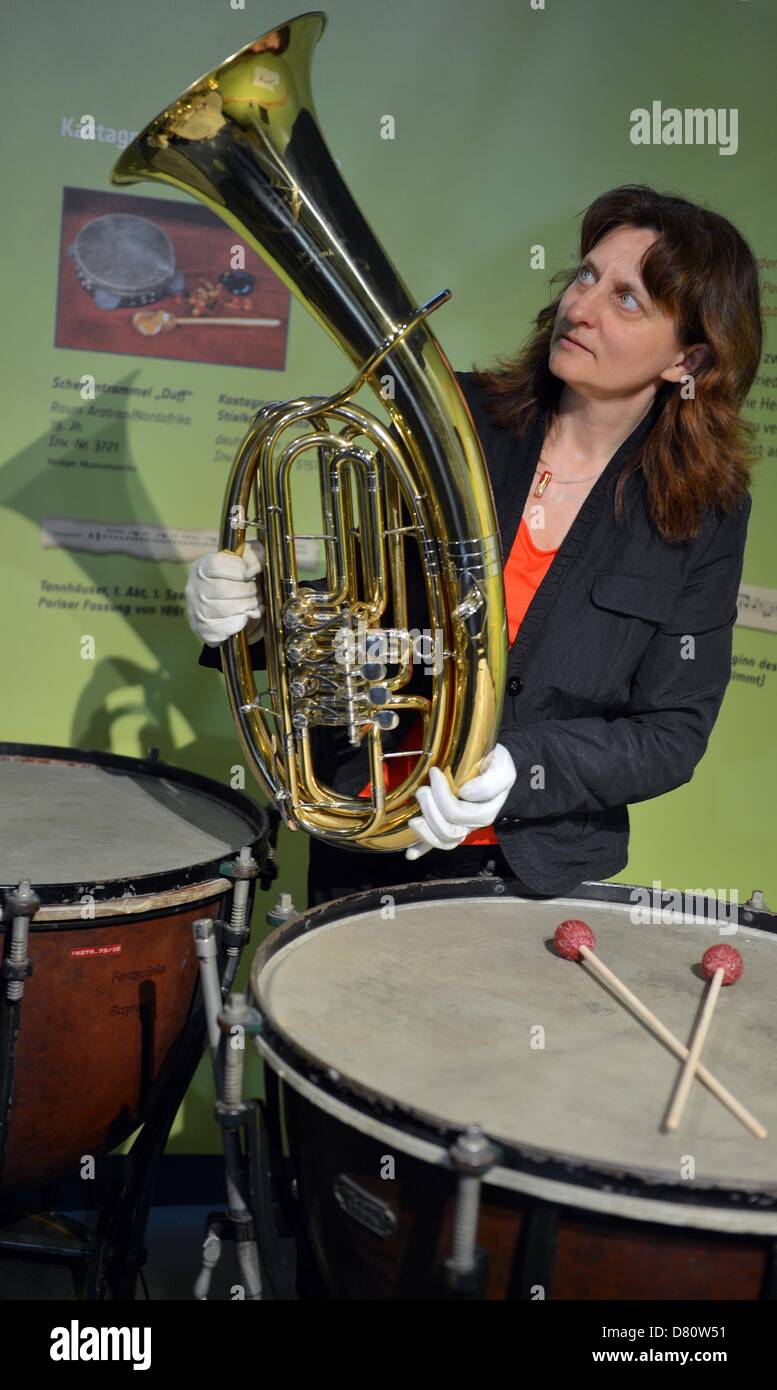 Curator Birgit Heise stands with a Wagner tuba from the Bayreuth