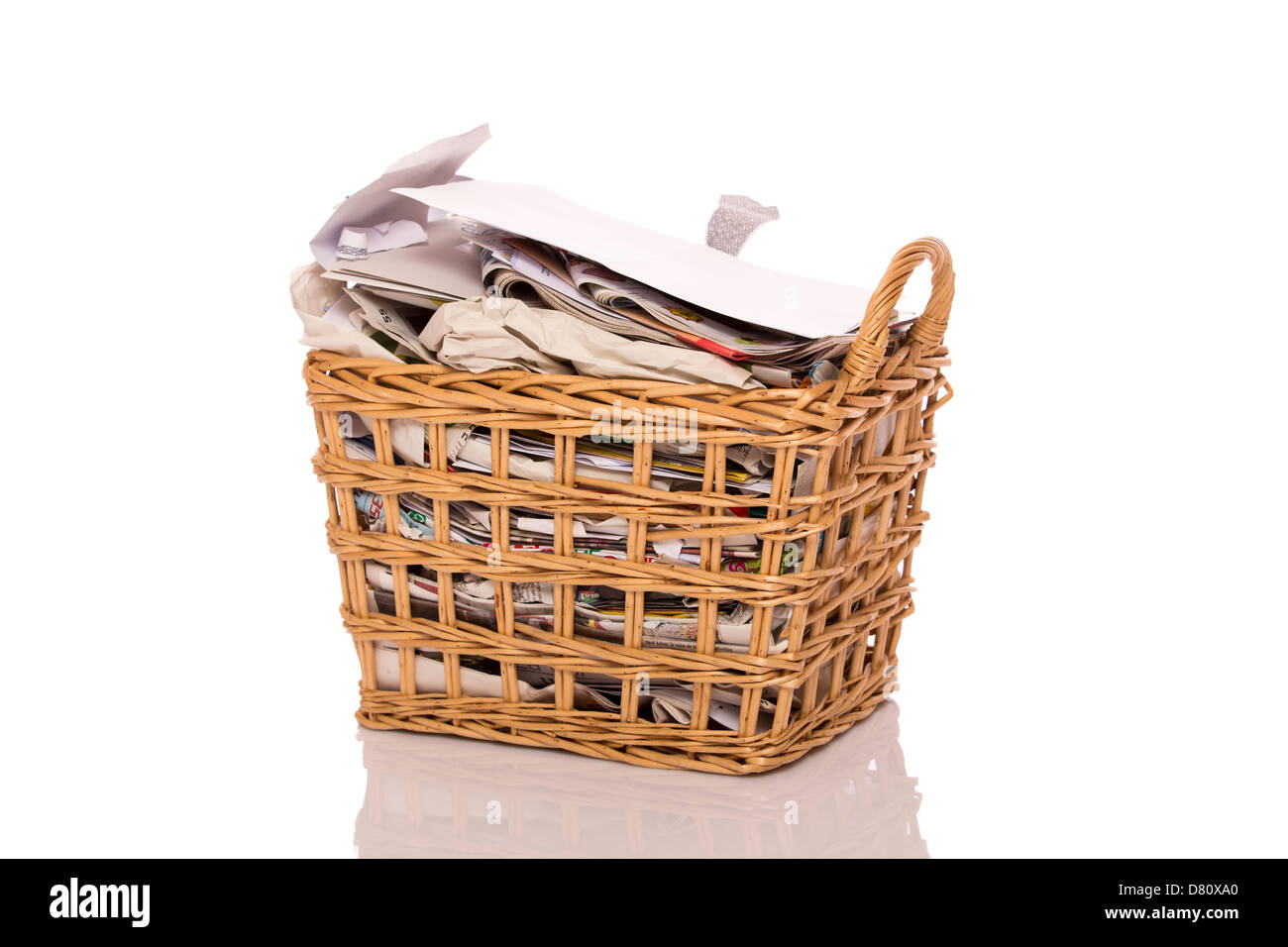 Full wastepaper basket isolated on white background Stock Photo